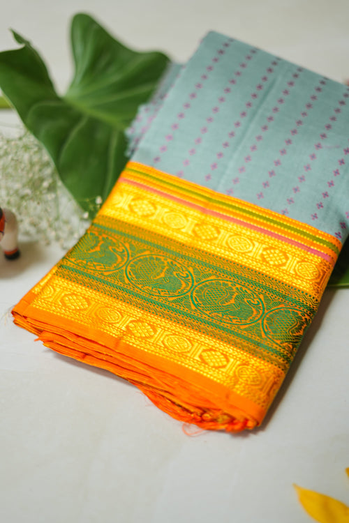 Aakasha silk saree: sky-blue dotted body, mango and leaf-green border (folded)