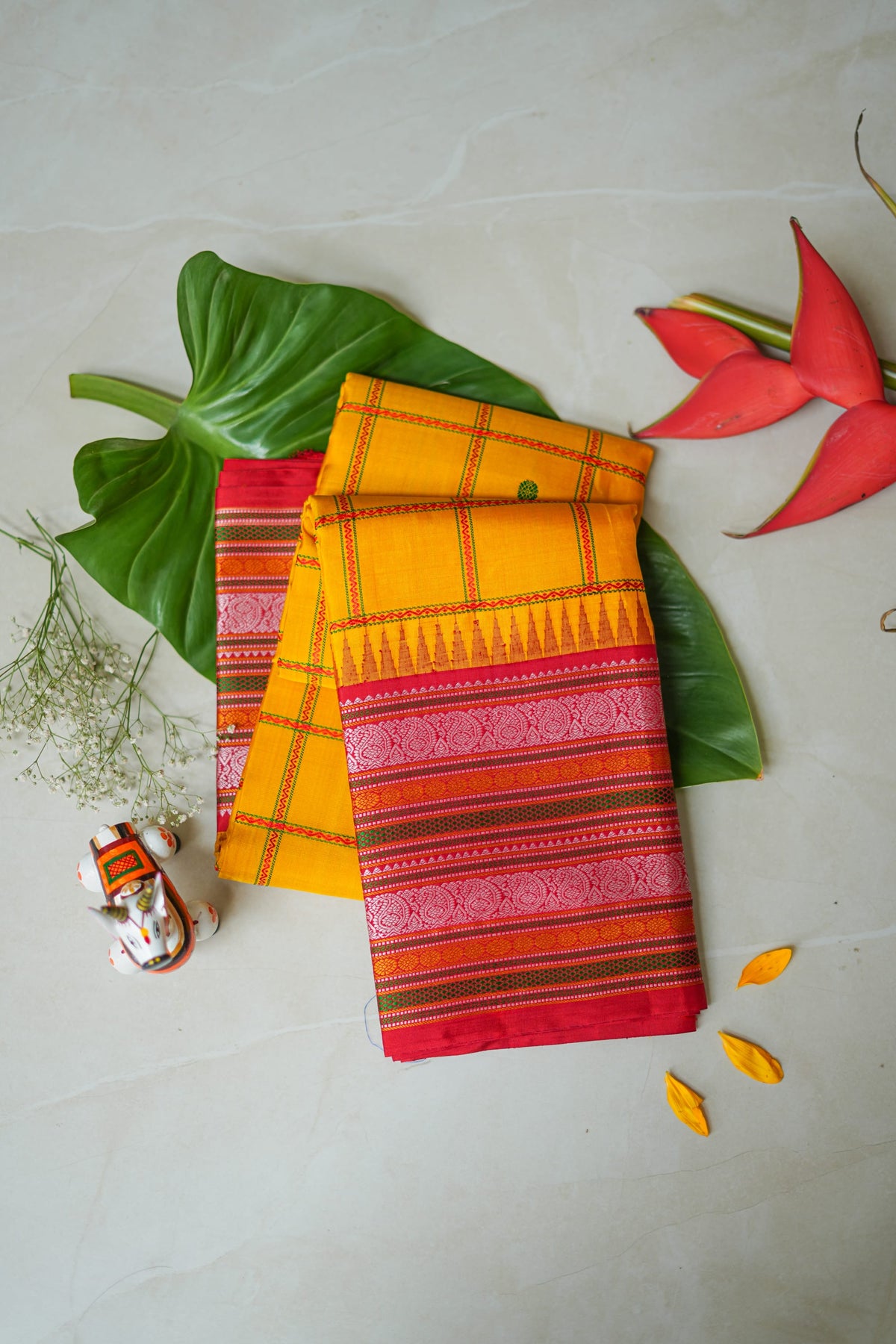 Arishina silk saree: turmeric checks with a red temple border (folded)