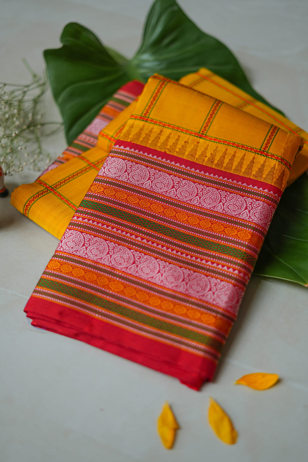 Arishina silk saree: turmeric checks with a red temple border (folded)