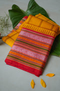 Arishina silk saree: turmeric checks with a red temple border (folded)