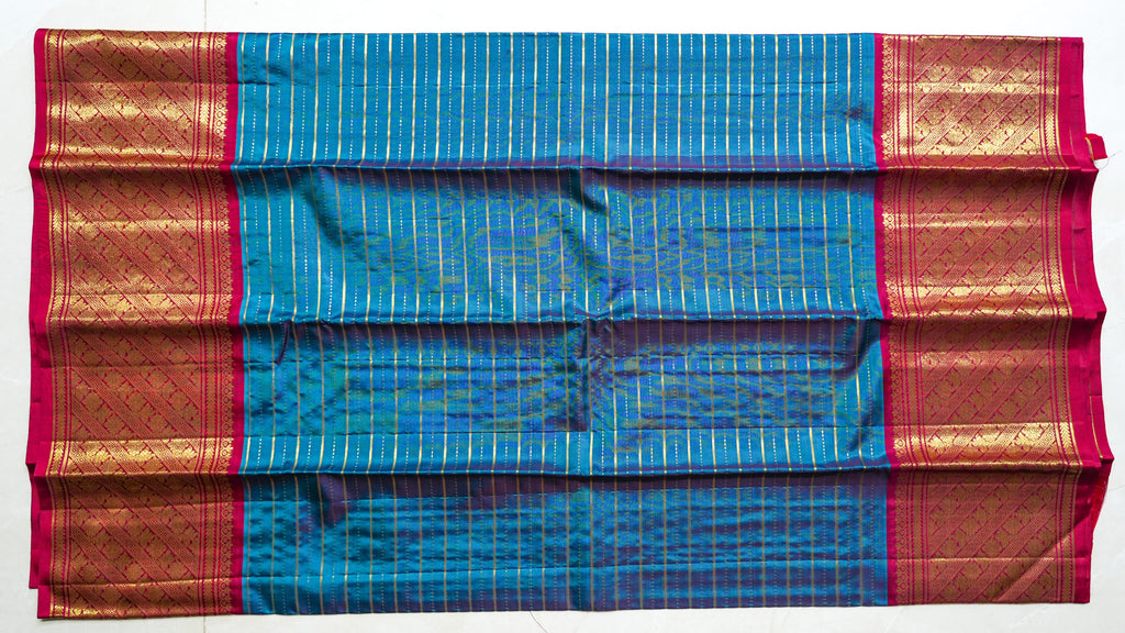 Turquoise Silk Saree with Gold Stripes: turquoise silk with gold zari stripes and a rani pink brocade pallu (laid flat)