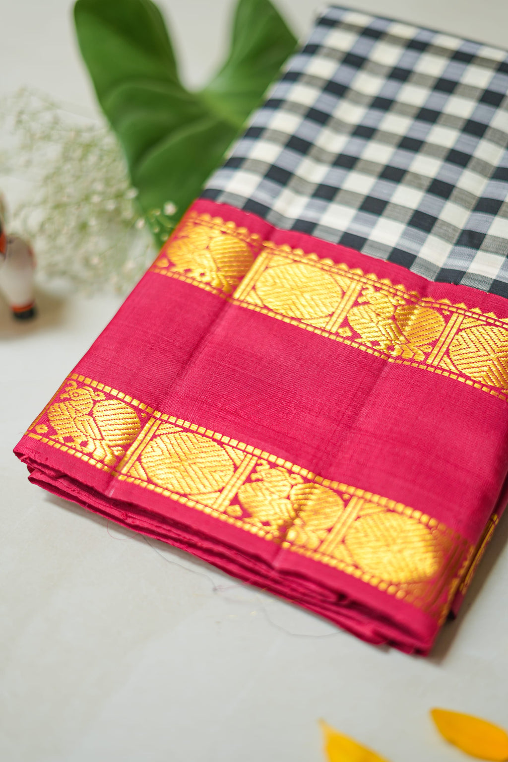 Chaduranga silk saree: ivory-and-ink checks, rani pink zari border (folded)