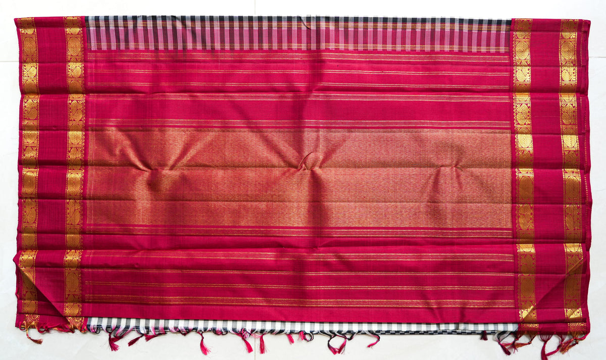 Chaduranga silk saree: ivory-and-ink checks, rani pink zari border (laid flat)