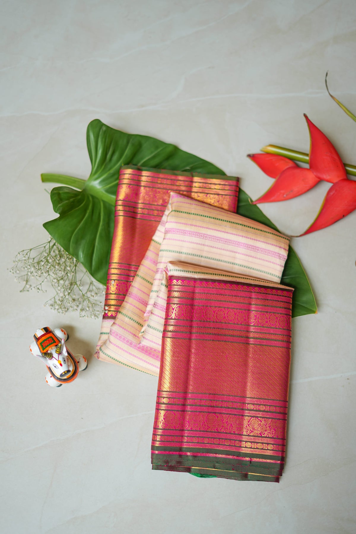 Cream & Pink Striped Silk Saree: cream silk with pink pinstripes and a maroon and gold zari border (folded)