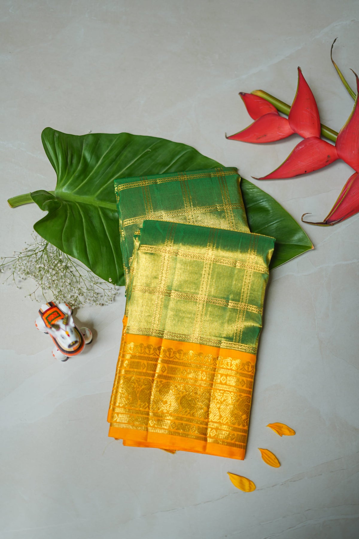 Green Silk Saree with Gold Checks: bottle-green silk with gold zari checks and a mustard border (folded)