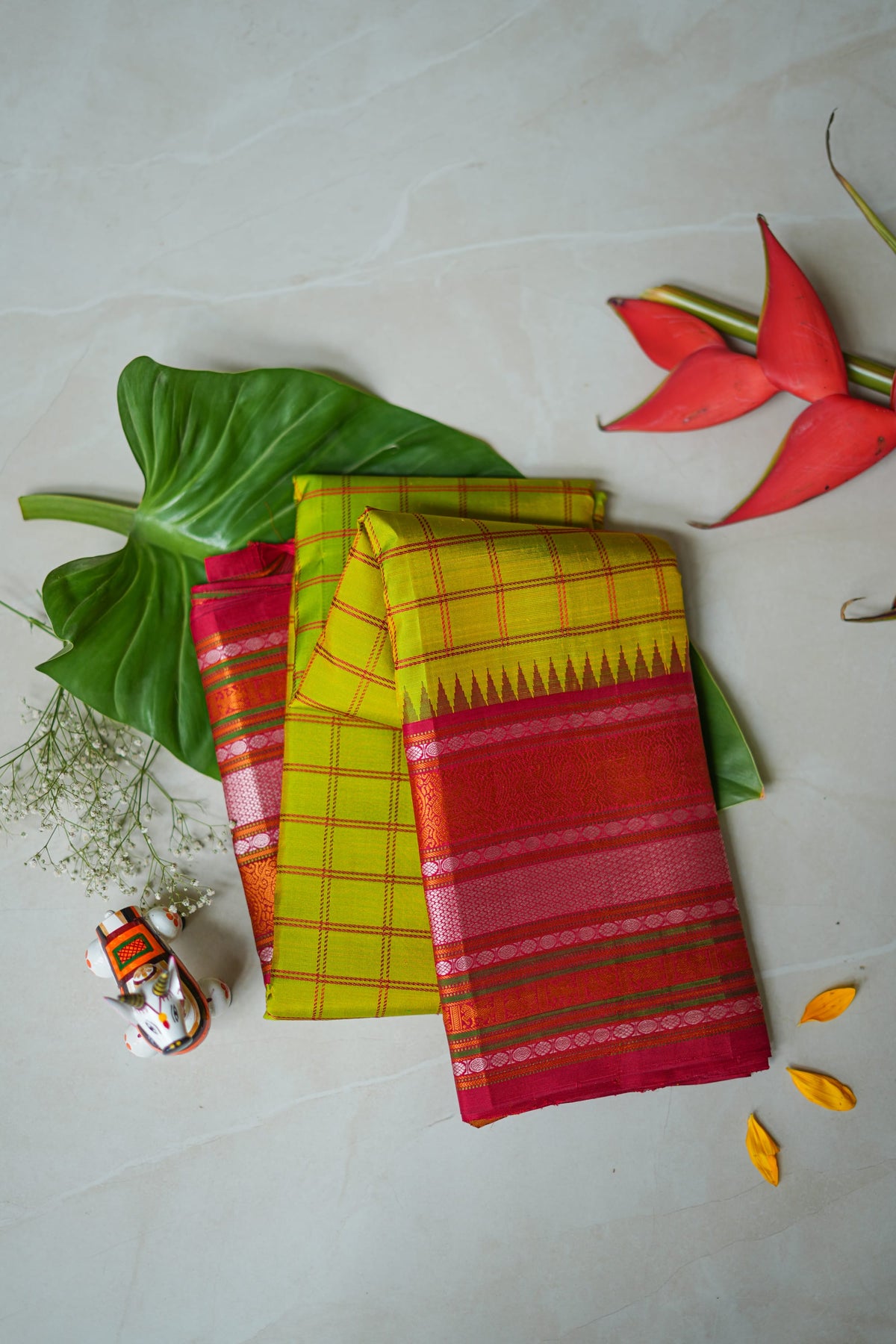 Haritha silk saree: parrot-green checks, red temple border (folded)