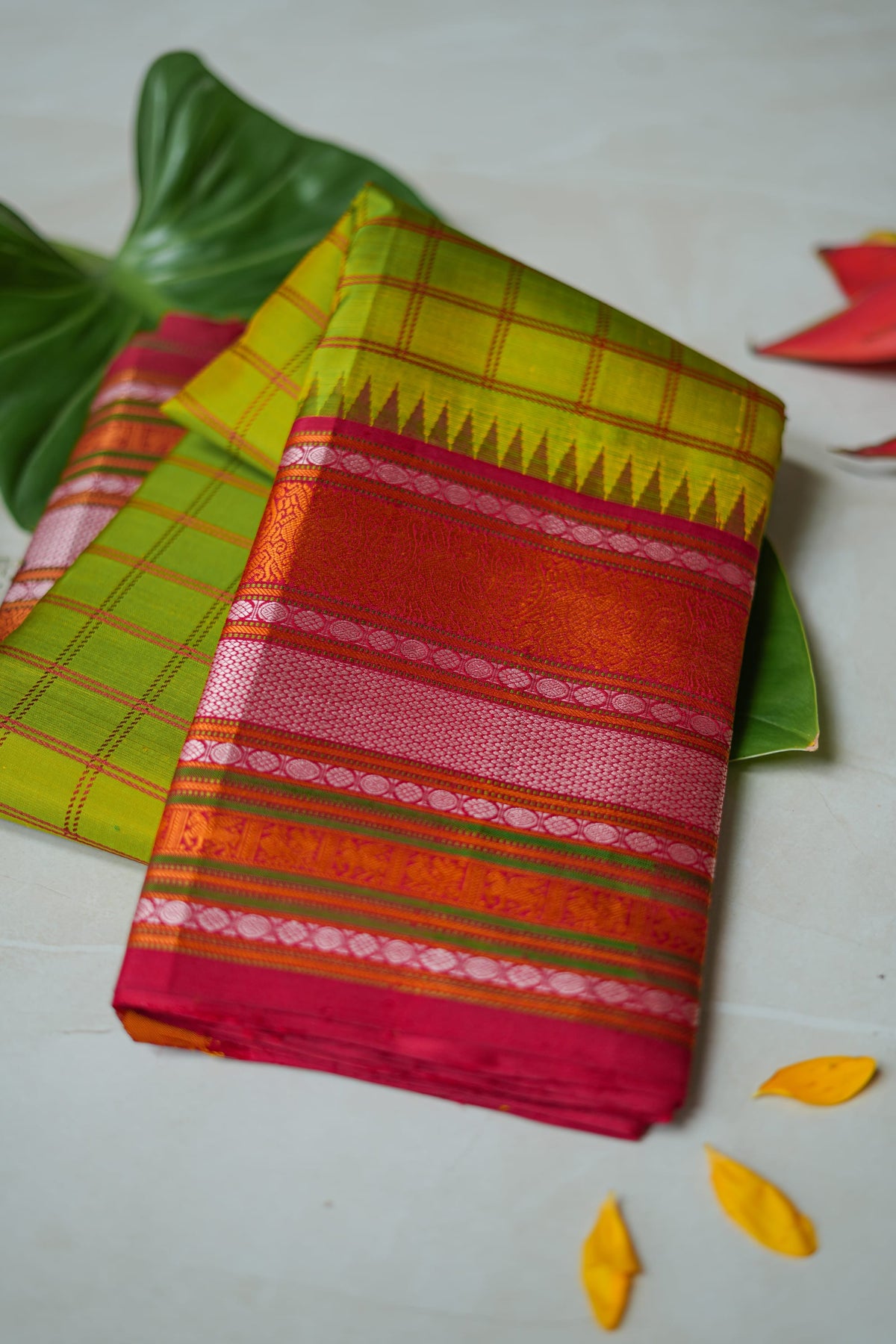 Haritha silk saree: parrot-green checks, red temple border (folded)