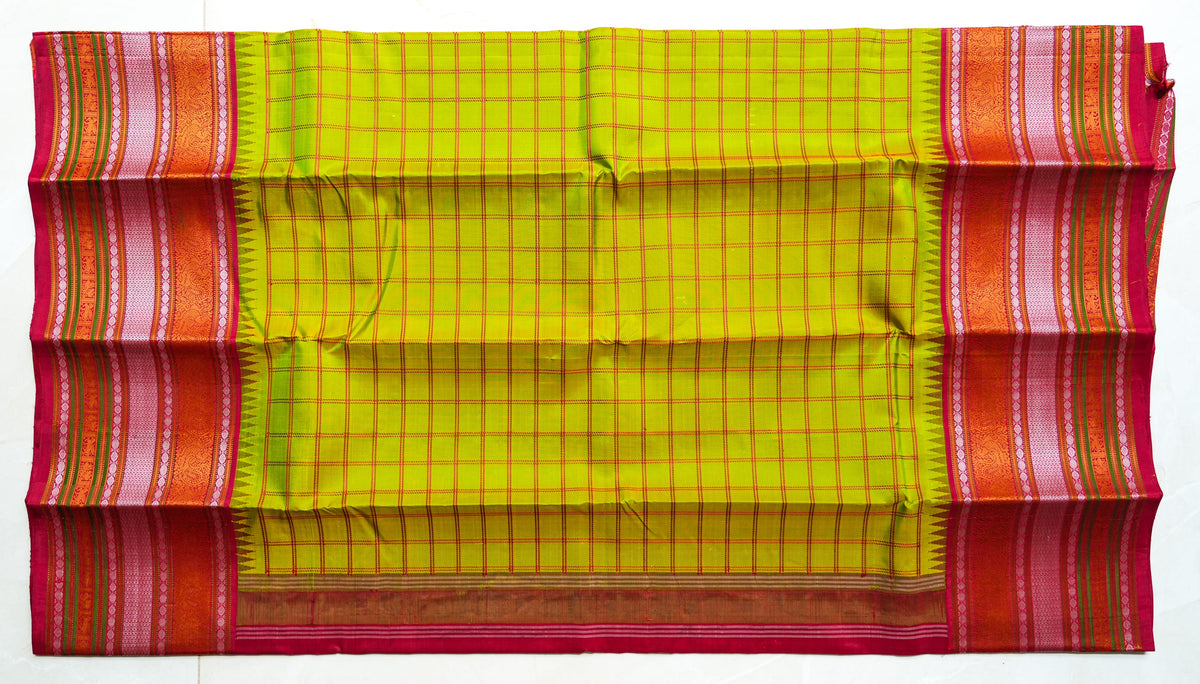 Haritha silk saree: parrot-green checks, red temple border (laid flat)