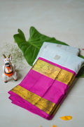 Ivory Silk Saree with Magenta Border: ivory silk with small gold butas and a magenta and gold zari border (folded)