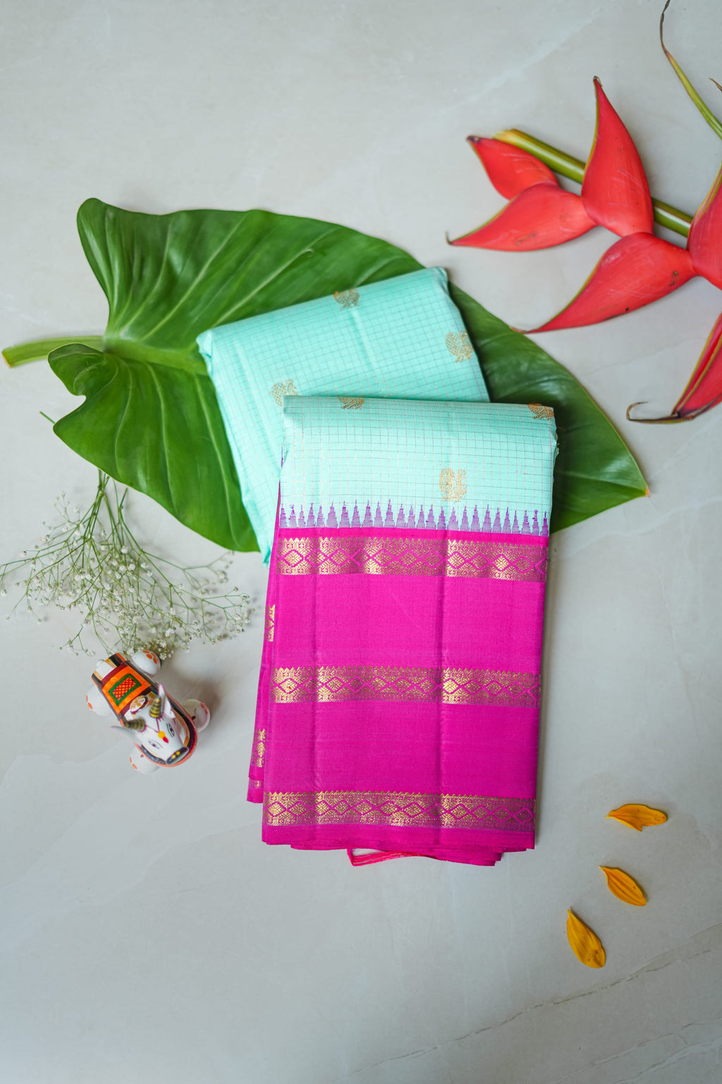 Kamala silk saree: aqua silk with a rani pink zari border (folded)
