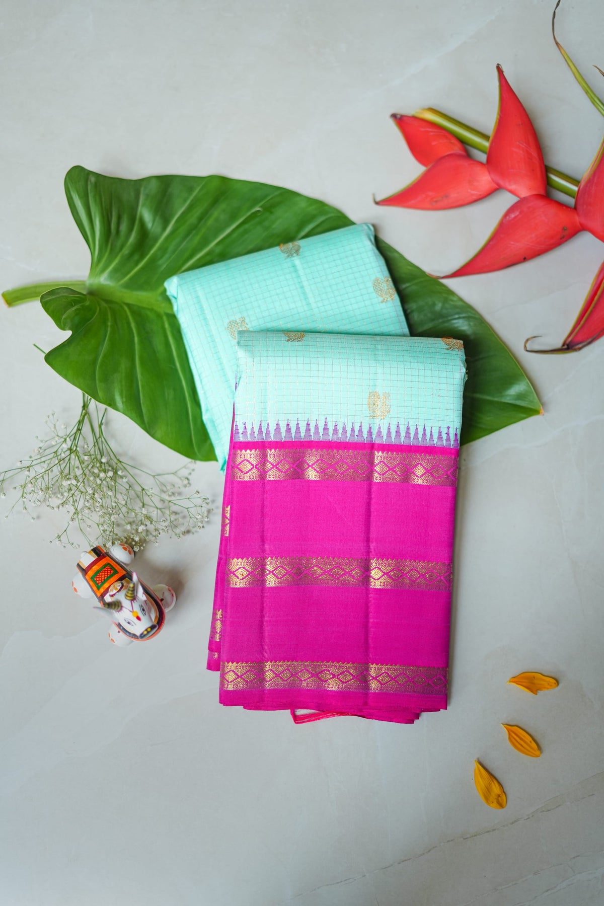 Kamala silk saree: aqua silk with a rani pink zari border (folded)