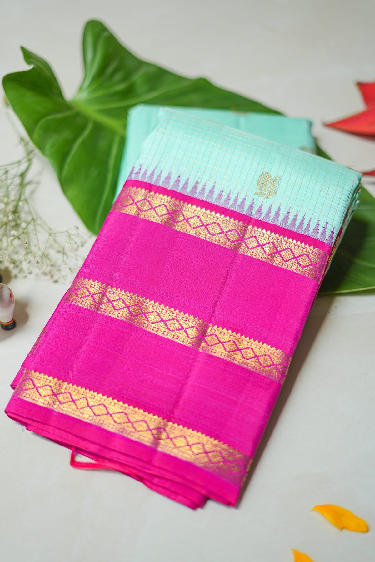 Kamala silk saree: aqua silk with a rani pink zari border (folded)