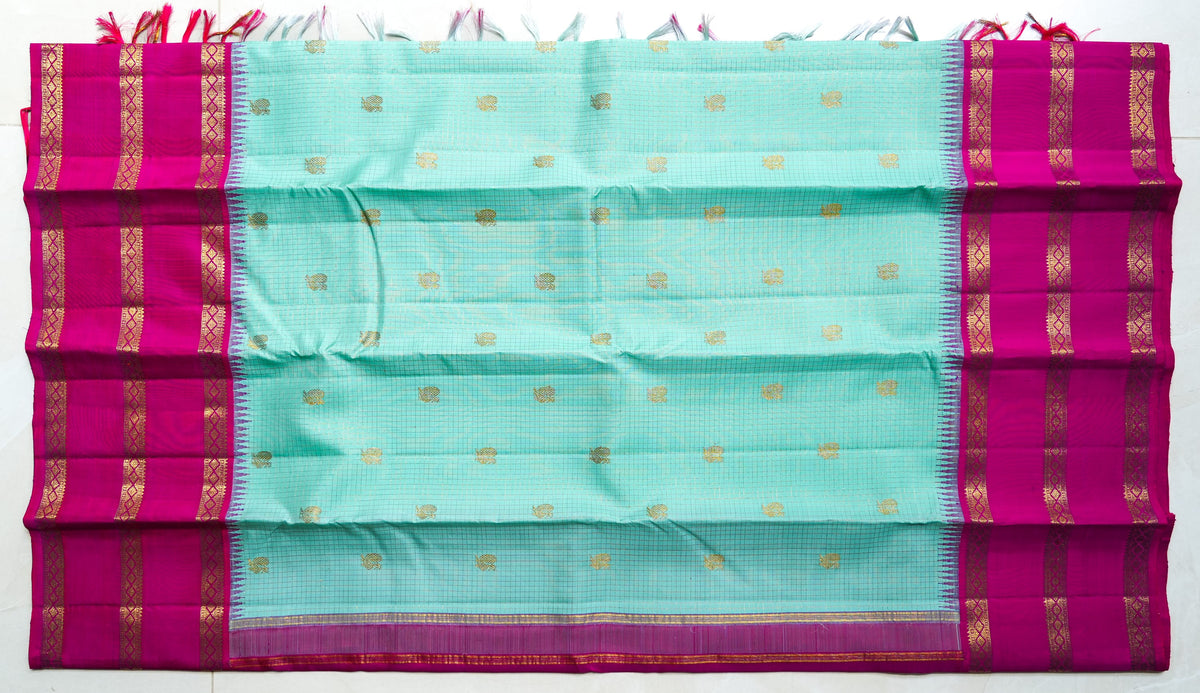 Kamala silk saree: aqua silk with a rani pink zari border (laid flat)