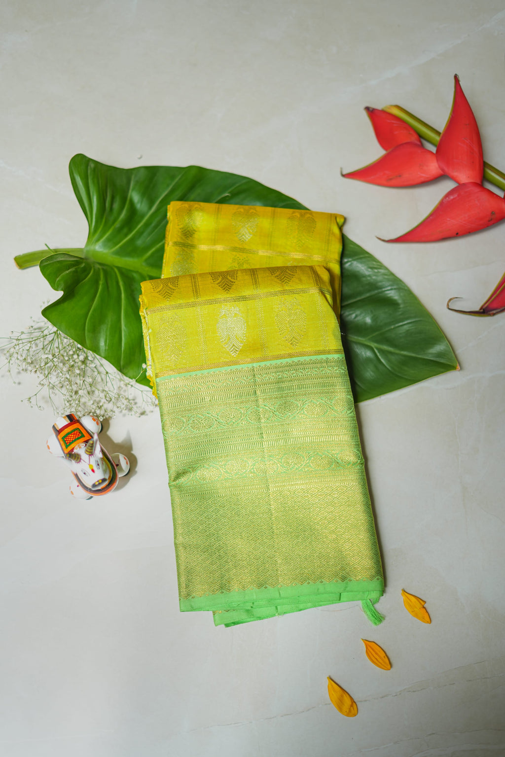 Lemon Yellow Silk Saree with Lime Green Border: lemon-yellow silk with gold butas and a lime-green zari border (folded)