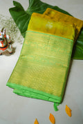 Lemon Yellow Silk Saree with Lime Green Border: lemon-yellow silk with gold butas and a lime-green zari border (folded)