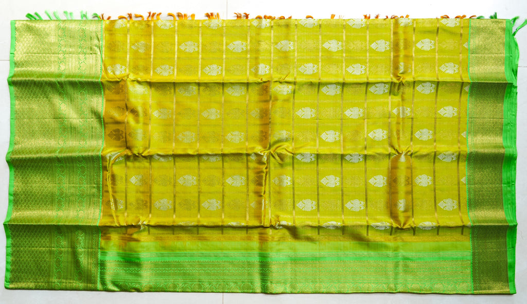Lemon Yellow Silk Saree with Lime Green Border: lemon-yellow silk with gold butas and a lime-green zari border (laid flat)