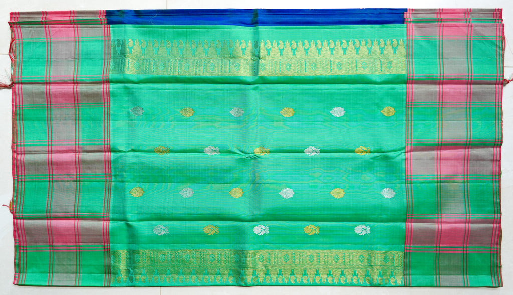 Mint & Pink Checked Silk Saree: mint-green and pink checks with gold butas and a royal-blue edge (laid flat)