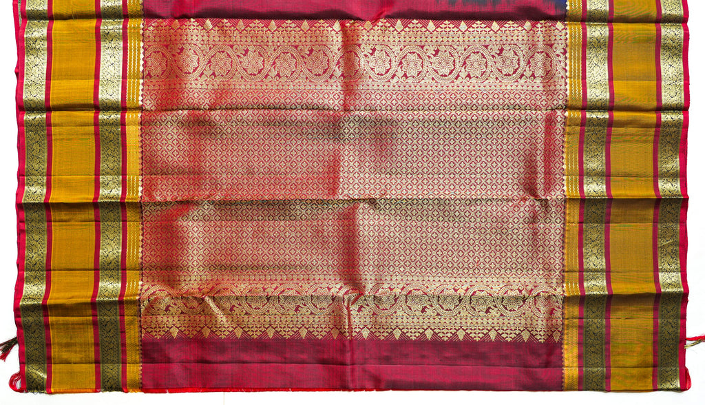Navy Silk Saree with Mustard Border: navy silk with gold butas, a mustard and red zari border and a peach brocade pallu (laid flat)