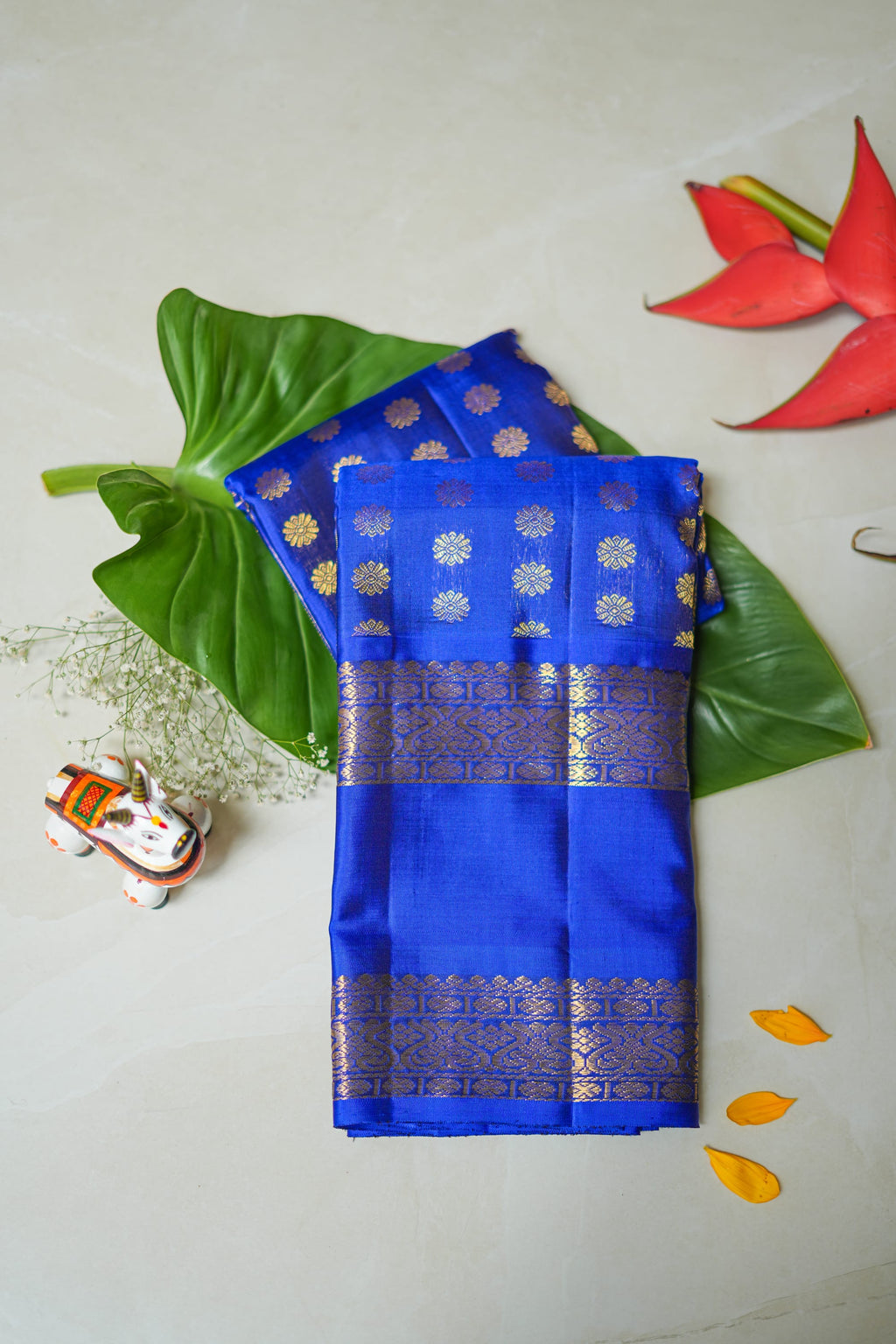 Neela Butta silk saree: royal blue silk scattered with gold butas (folded)
