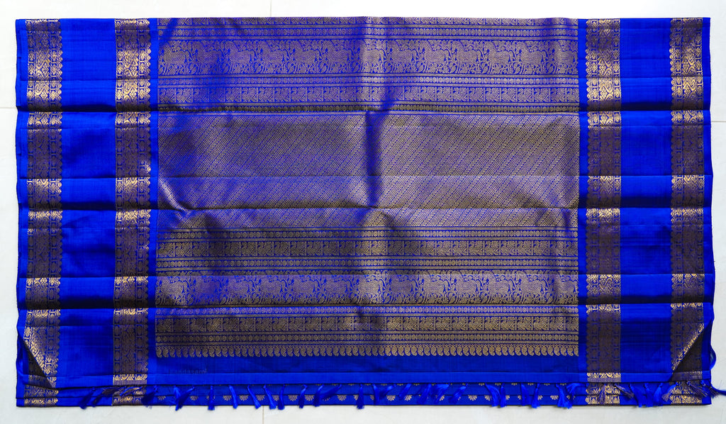 Neela Butta silk saree: royal blue silk scattered with gold butas (laid flat)