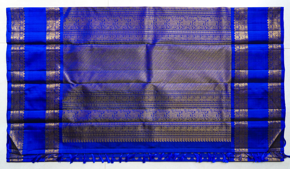 Neela Butta silk saree: royal blue silk scattered with gold butas (laid flat)