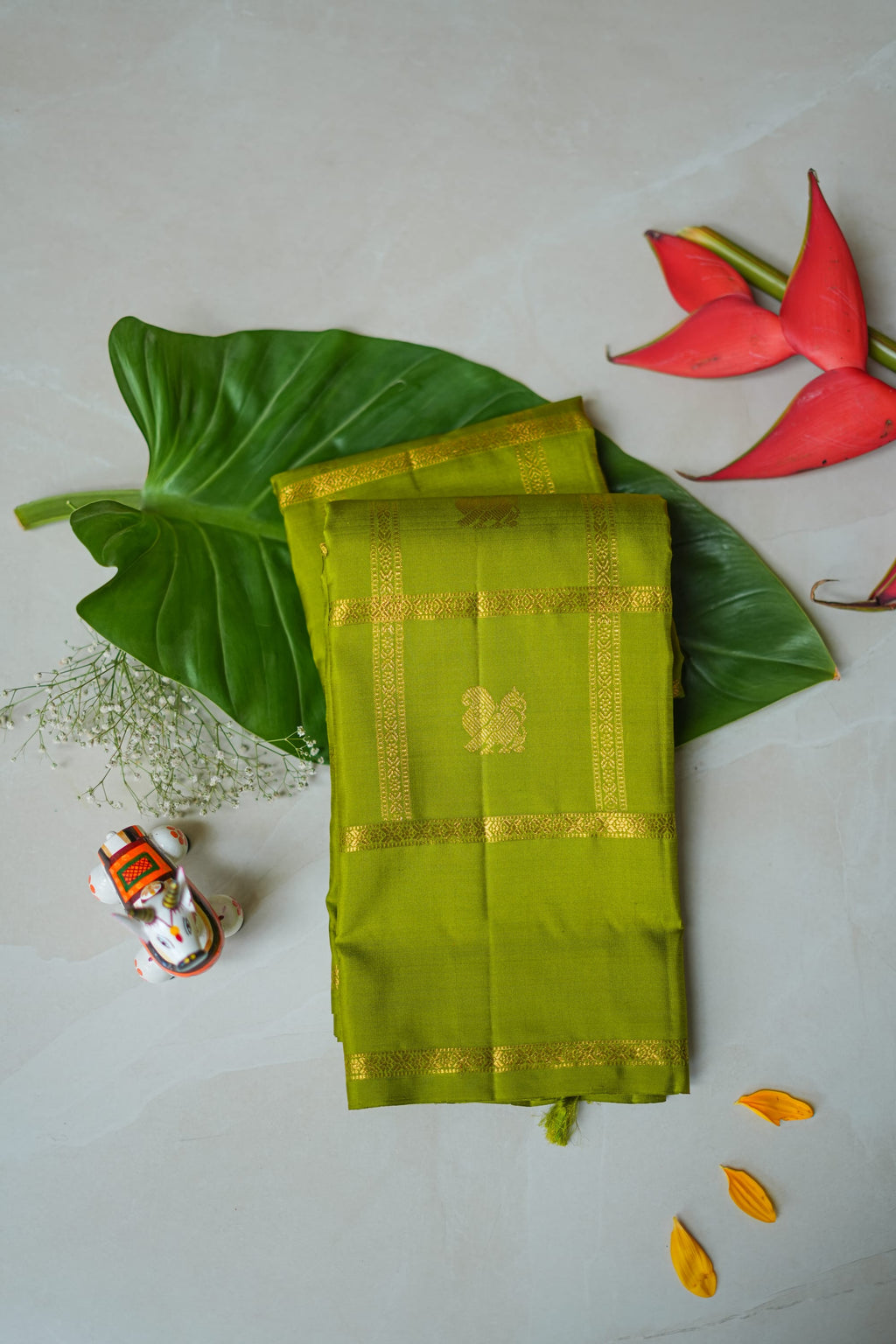 Olive Green Silk Saree with Gold Butas: olive-green silk with gold butas set in zari squares (folded)
