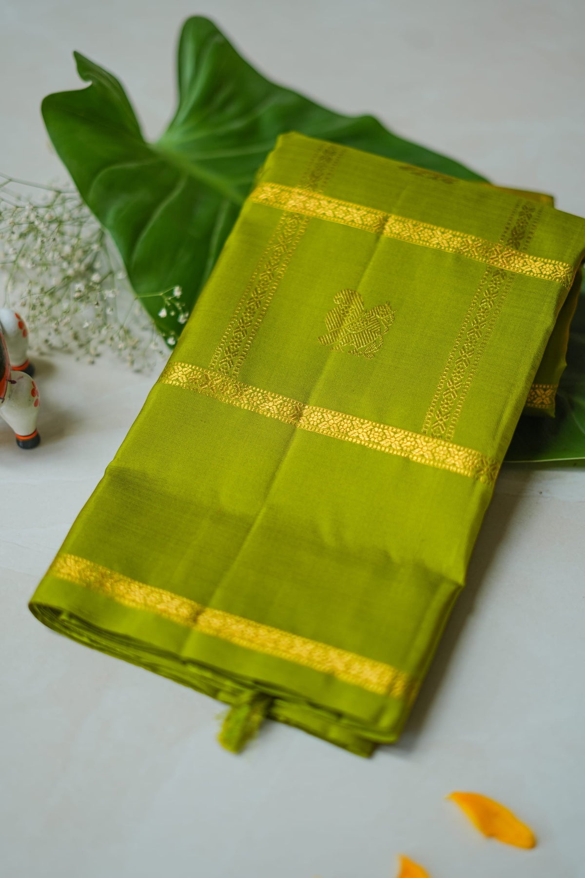 Olive Green Silk Saree with Gold Butas: olive-green silk with gold butas set in zari squares (folded)
