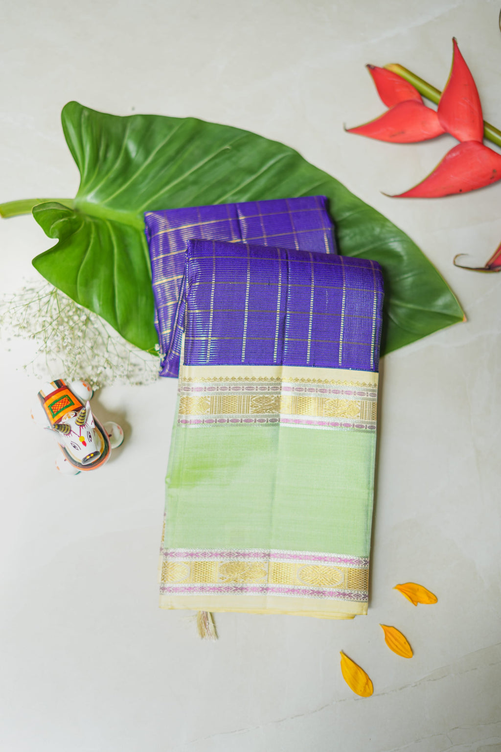 Purple Checked Silk Saree with Pistachio Border: purple zari checks with a pistachio-green border and a cream pallu (folded)