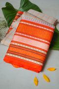 Sindhoora silk saree: peach checks with a vermilion temple border (folded)