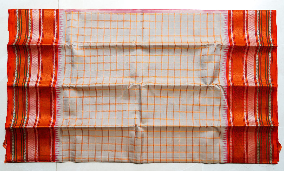 Sindhoora silk saree: peach checks with a vermilion temple border (laid flat)