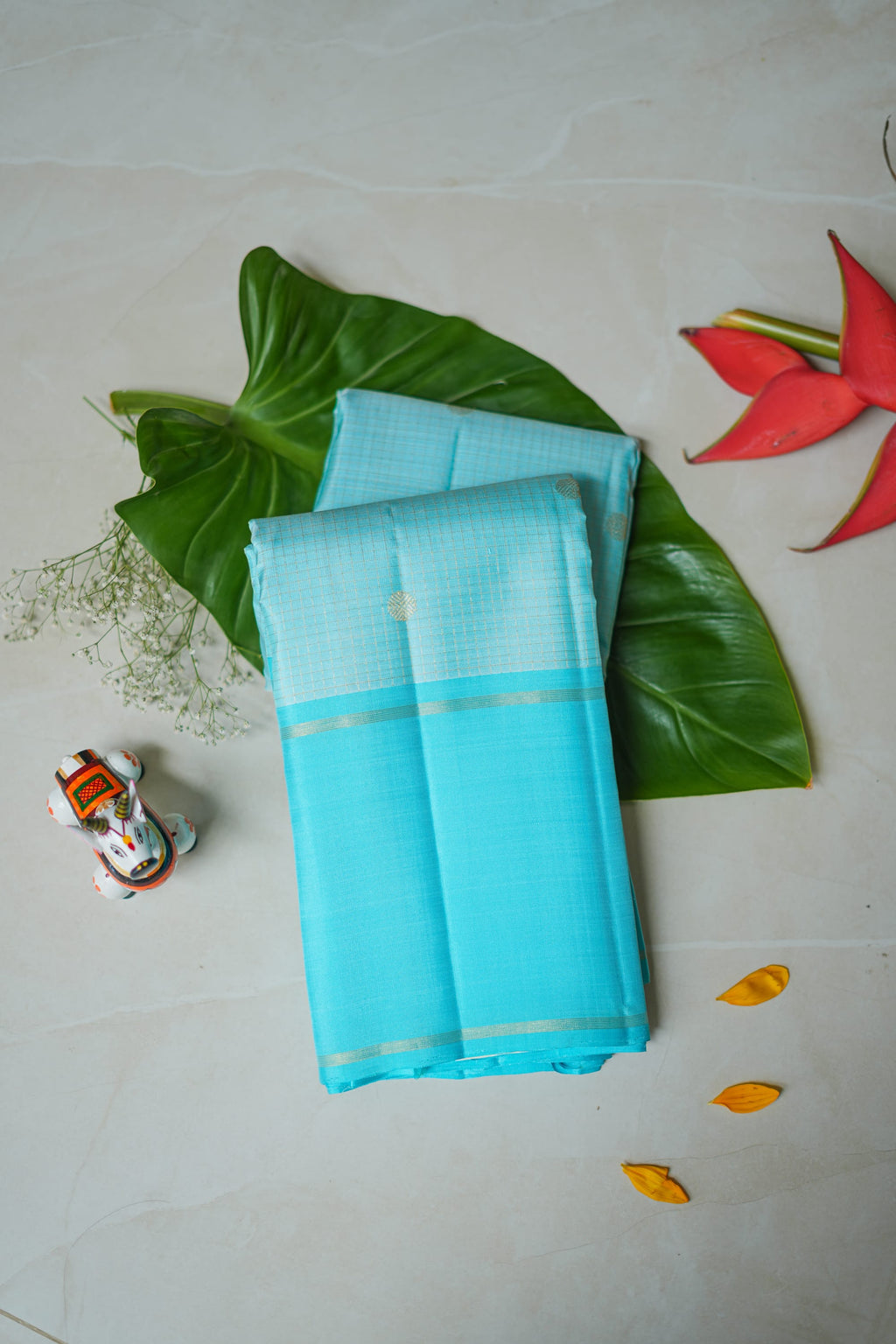 Sky Blue Silk Saree: sky-blue silk with tiny gold butas and fine zari lines (folded)