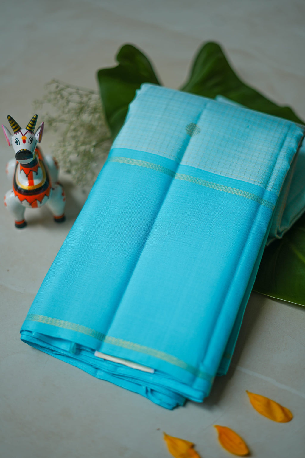 Sky Blue Silk Saree: sky-blue silk with tiny gold butas and fine zari lines (folded)