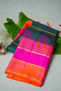 Teal Checked Silk Saree with Pink Temple Border: teal-green zari checks with a rani pink temple border and an orange edge (folded)