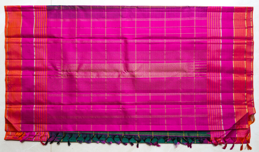 Teal Checked Silk Saree with Pink Temple Border: teal-green zari checks with a rani pink temple border and an orange edge (laid flat)