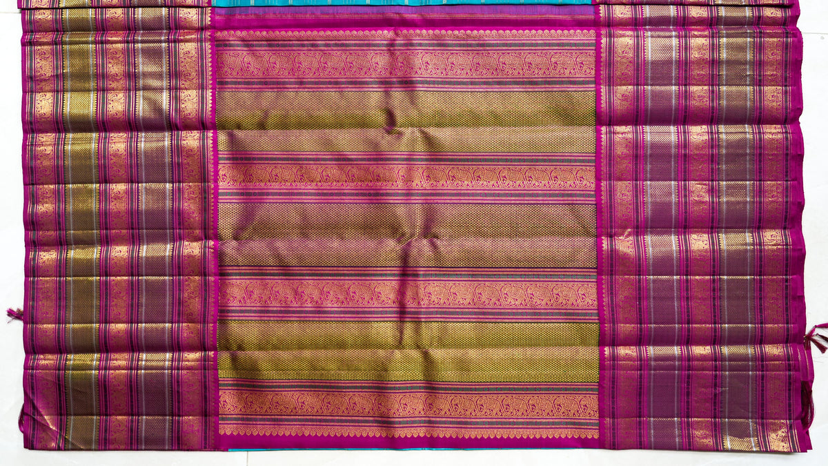 Utsava silk saree: rani pink with gold brocade stripes (laid flat)
